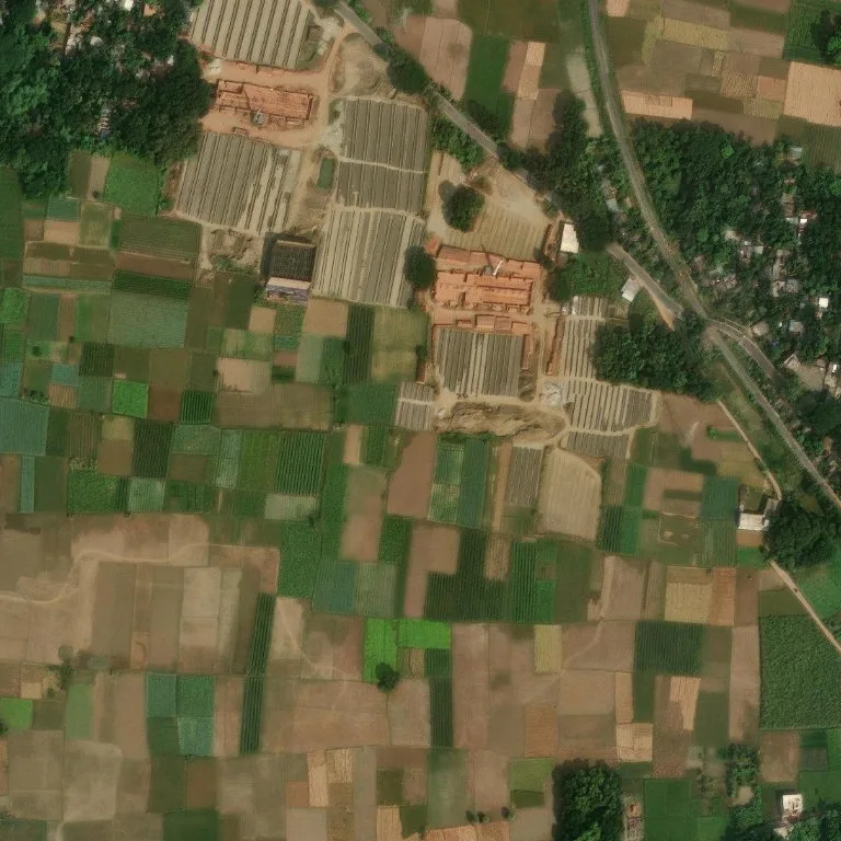 Brick kiln beside dense green fields in Bangladesh